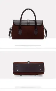 Macro view of retro tote bag bottom featuring protective metal studs and leather details