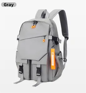 Detail view of light grey backpack with orange accents and breathable mesh straps
