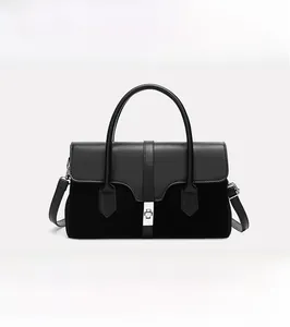 Detail of vintage black two-tone texture tote with elegant metal lock and top handle