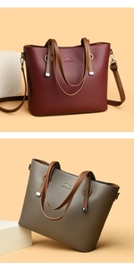 Detail of lychee pattern leather tote bags in burgundy and grey with kangaroo logo