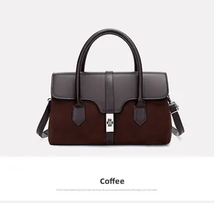 Detail view of coffee brown patchwork leather tote with a metallic square lock