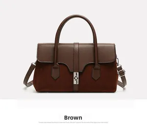 Detail of vintage bicolor tote with leather contrast, suede texture and silver swivel lock
