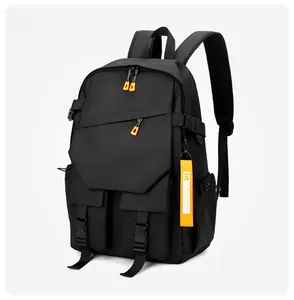 Detail of waterproof black backpack with orange zipper pulls and breathable mesh straps