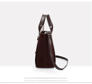 Side view of dark brown bucket bag featuring contrast faux suede and smooth leather textures