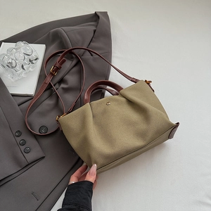 Olive green canvas handbag with vintage pleated design and brown leather straps