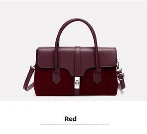 Detail view of burgundy tote bag with leather texture and silver metal clasp