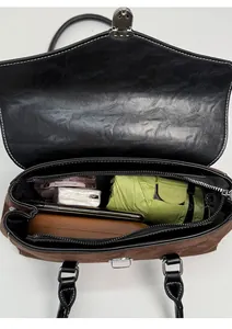 Detailed interior view of a retro shoulder bag showing daily storage capacity for essentials