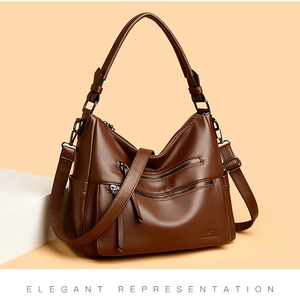 Detail of dark brown pebble leather shoulder bag showing multiple zipper pockets