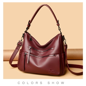 Detail view of burgundy leather tote bag showing lychee grain and kangaroo logo engraving