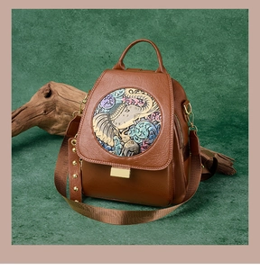 Macro view of vintage brown bag featuring embossed colorful elephant art and metal studs