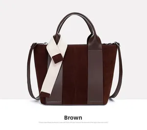 Detail view of brown patchwork tote bag featuring suede textures and a beige fabric strap