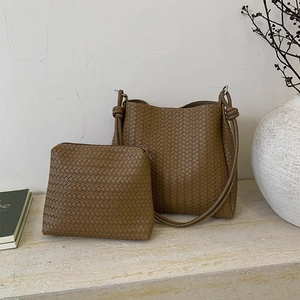 Woven bucket bag with matching pouch in dark brown leather featuring knot strap detail
