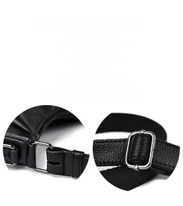 Detail of black litchi grain leather texture and silver adjustable metal buckle on bag