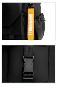 Detail of waterproof nylon backpack with orange strap charm and heavy-duty buckle