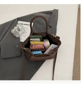 Spacious interior of dark brown retro wing bag showing phone and wallet storage