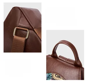 Close-up of reinforced stitching and floral embossed leather on a brown backpack