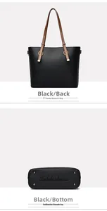 Detail of black pebbled leather tote bag with brown straps and metal bottom studs