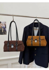 Retro suede baguette bag details showing minimalist design and vintage metal buckle clasp