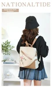 Outdoor lifestyle shot of woman wearing floral embroidery anti-theft backpack