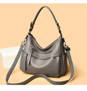 Detail of grey lychee leather tote bag with dual front zippers and kangaroo logo