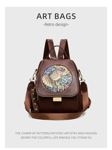 Detail of artistic floral elephant pattern and textured brown leather on art backpack