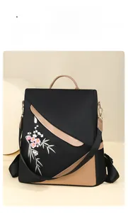 Detail of floral embroidery on a black and khaki anti-theft women backpack