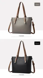 Detail of grey and black tote bags with lychee grain texture and kangaroo logo