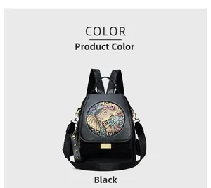 Detail of black backpack with colorful elephant floral relief and gold hardware accents