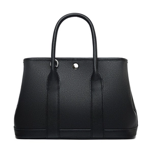 Black pebbled leather tote bag with silver snap button closure and cylindrical handles