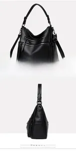 Detail of black pebbled leather tote bag with triple front zippers and kangaroo logo