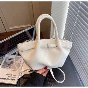 Detail of cream leather handbag with pleated design and gold metal buckle hardware