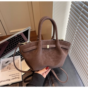Detail of coffee brown matte faux leather tote bag with elegant golden square buckle