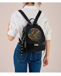 Detailed view of the artistic elephant relief on the black leather backpack for women