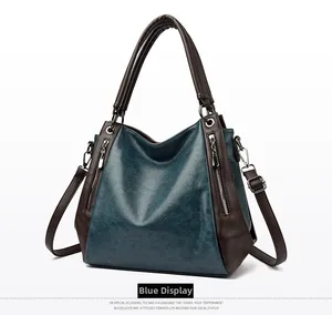 Macro view of blue waxed leather texture and metal zipper detail on retro tote bag