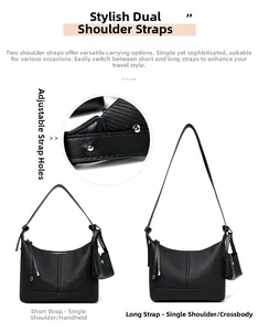 Detail of black textured faux leather baguette bag with detachable straps and mini pouch