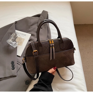 Detail of vintage rhombic shell bag with dual zippers and high-end matte leather texture