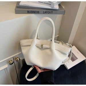 Close-up of cream white pleated handbag featuring a unique wave design and metal buckle detail