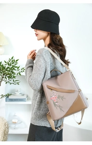 Fashionable taupe water-resistant backpack for women with floral embroidery and brown trim