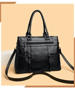 Close-up of black retro tote bag with dual handles and stylish zipper details