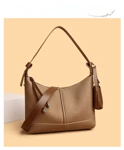 Detail of a brown woven texture shoulder bag with mini charm and smooth leather strap