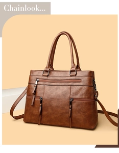 Detail view of brown vintage PU leather tote bag with functional front zipper pockets