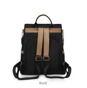 Detail view of the anti-theft back zipper opening on a black nylon backpack with brown straps