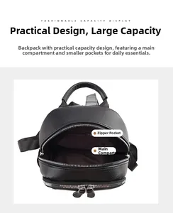 Detail view of the black pebbled leather backpack showing the main zipper and inner pocket