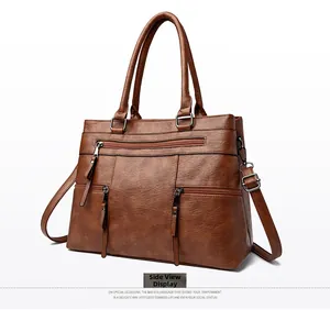 Side view of brown retro PU leather tote bag with three decorative front zippers