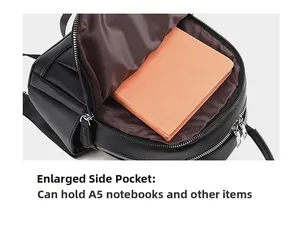 Macro view of a black leather backpack side pocket holding an A5 orange notebook