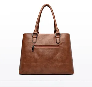 Rear view of brown textured leather tote bag featuring a horizontal metal zipper pocket