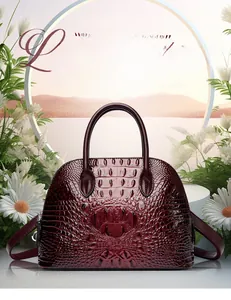 Close-up of wine red shell handbag with crocodile pattern texture and metallic zipper