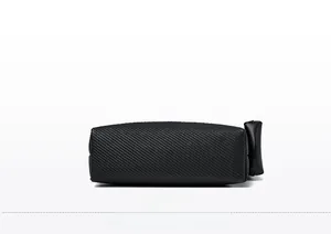 Detail view of the black textured leather handbag bottom with reinforced stitching