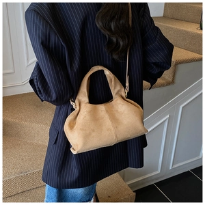 Close-up of khaki suede cloud pouch bag with soft pleated design and shoulder strap