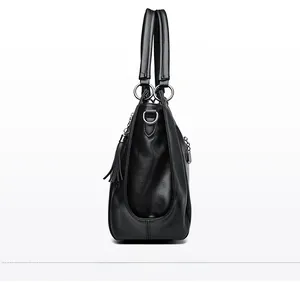 Detailed side view of black lychee grain tote bag with round handles and tassel zipper